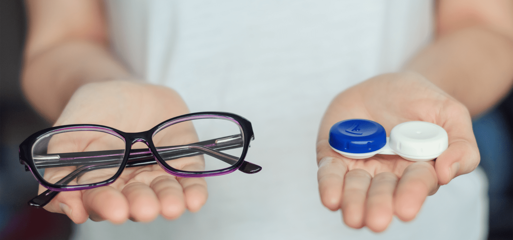 In one had a person hold a pair of eyeglasses, in the other the person holds the container for contact lenses