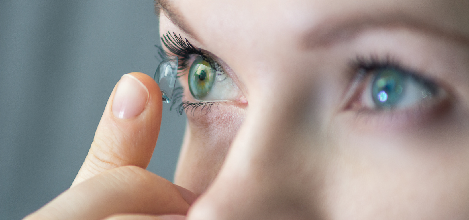 A woman demonstrates how to put in contacts