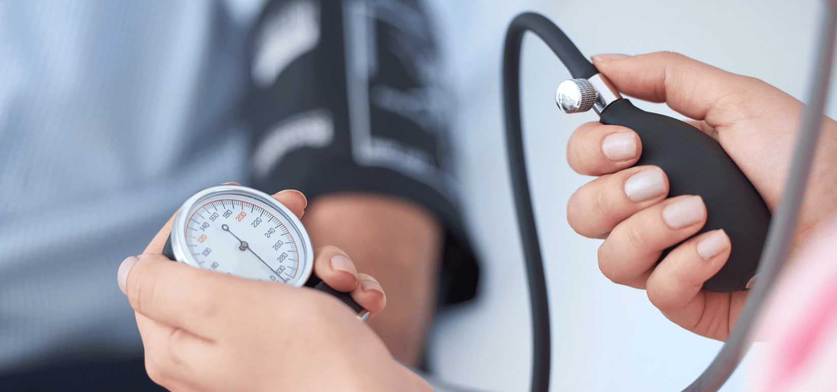 Patient having blood pressure checked by medical personnell with Sphygmomanometer 
